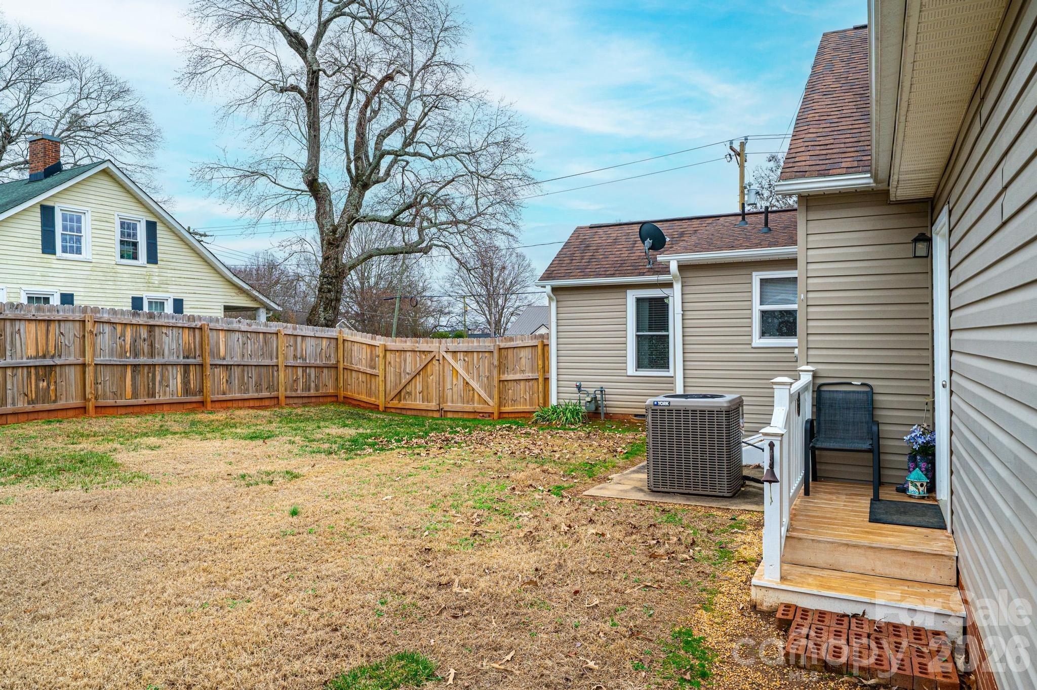 235 Spring Street Mocksville, NC 27028 - Photo 39 of 41 a backyard of a house with wooden floor and fence