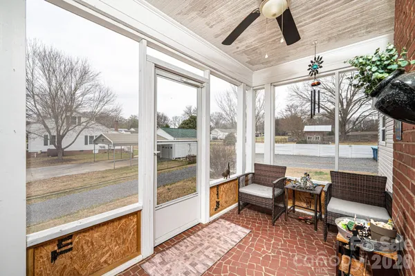 a living room with furniture and a floor to ceiling window