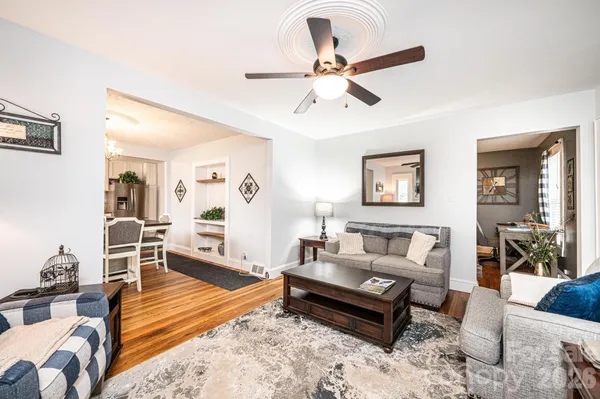 a living room with furniture and wooden floor
