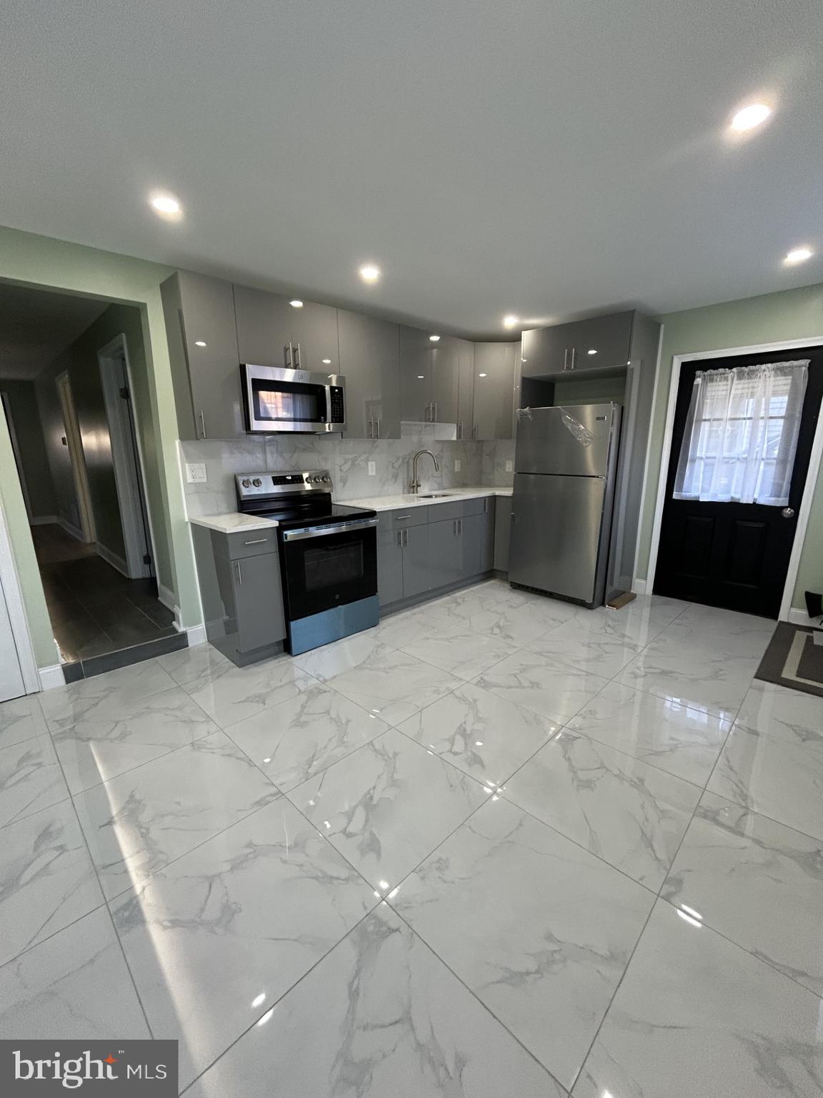 1420 Williams Avenue Levittown, PA 19057 - Photo 2 of 15 a kitchen with stainless steel appliances granite countertop a refrigerator and a sink
