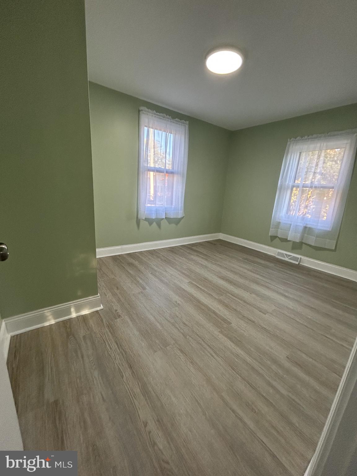 1420 Williams Avenue Levittown, PA 19057 - Photo 4 of 15 an empty room with wooden floor and windows