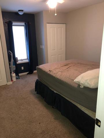 8420 South Main Street Rochelle, IL 61068 - Photo 22 of 24 a bed sitting in a bedroom next to a window