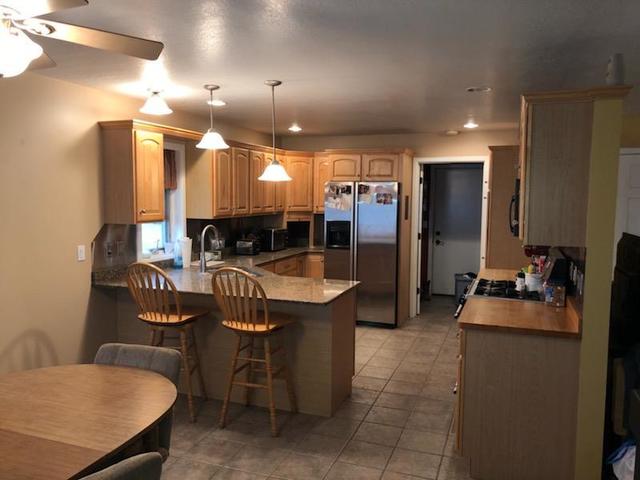 8420 South Main Street Rochelle, IL 61068 - Photo 8 of 24 a kitchen with refrigerator and chairs