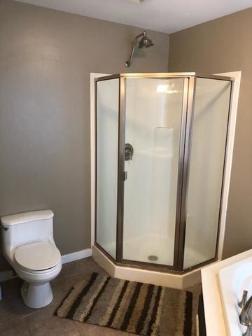 8420 South Main Street Rochelle, IL 61068 - Photo 10 of 24 a bathroom with a toilet and a glass door