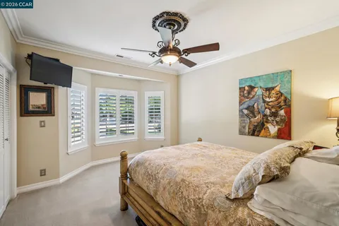 a bedroom with a bed a chandelier and a couch