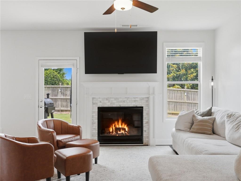 147 Fieldbrook Crossing Canton, GA 30115 - Photo 7 of 46 a living room with furniture a flat screen tv and a fireplace