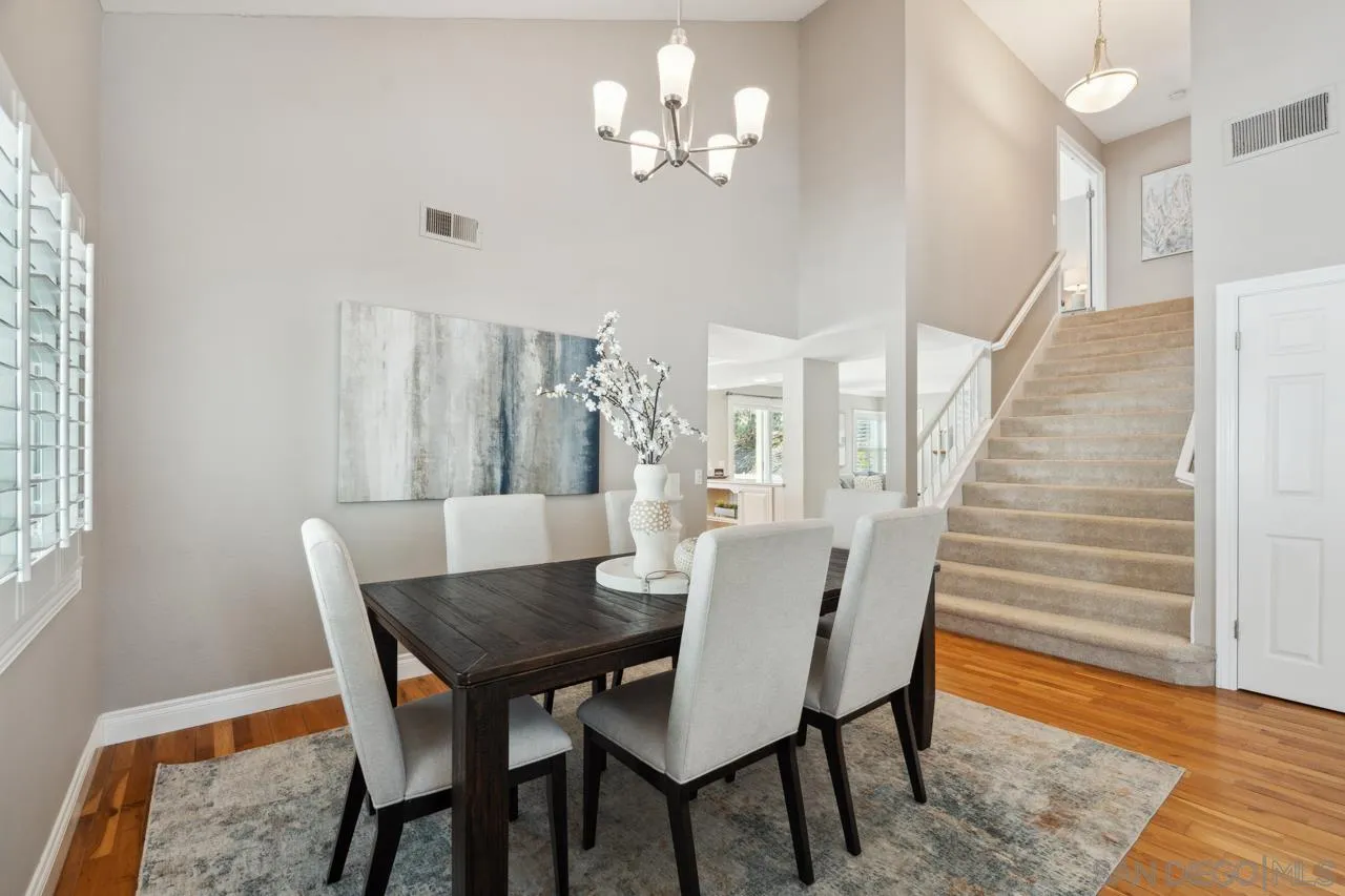 7914 Corte Cardo Carlsbad, CA 92009 - Photo 11 of 61 a view of a dining room with furniture and wooden floor