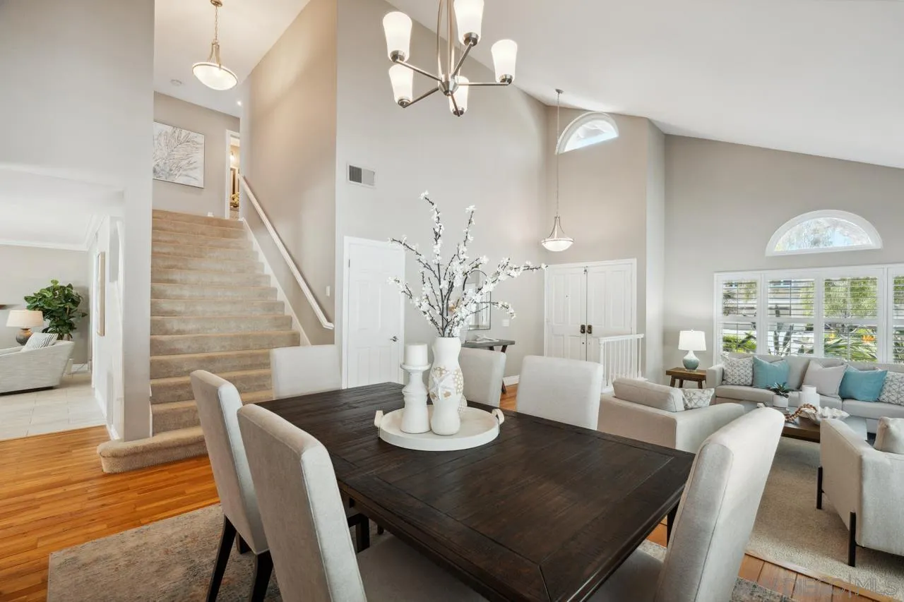 7914 Corte Cardo Carlsbad, CA 92009 - Photo 12 of 61 a view of a dining room with furniture and wooden floor