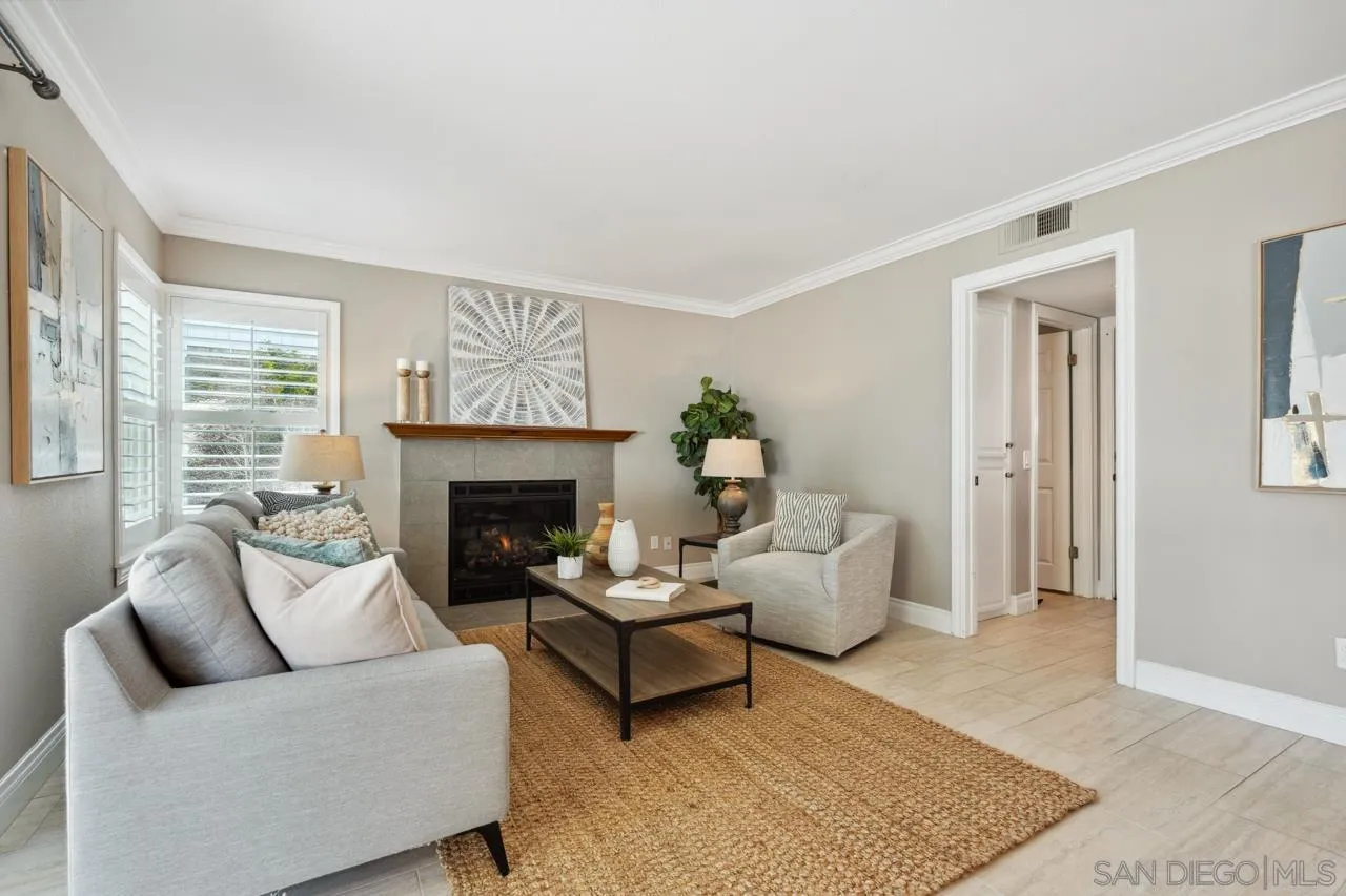 7914 Corte Cardo Carlsbad, CA 92009 - Photo 24 of 61 a living room with furniture and a fireplace