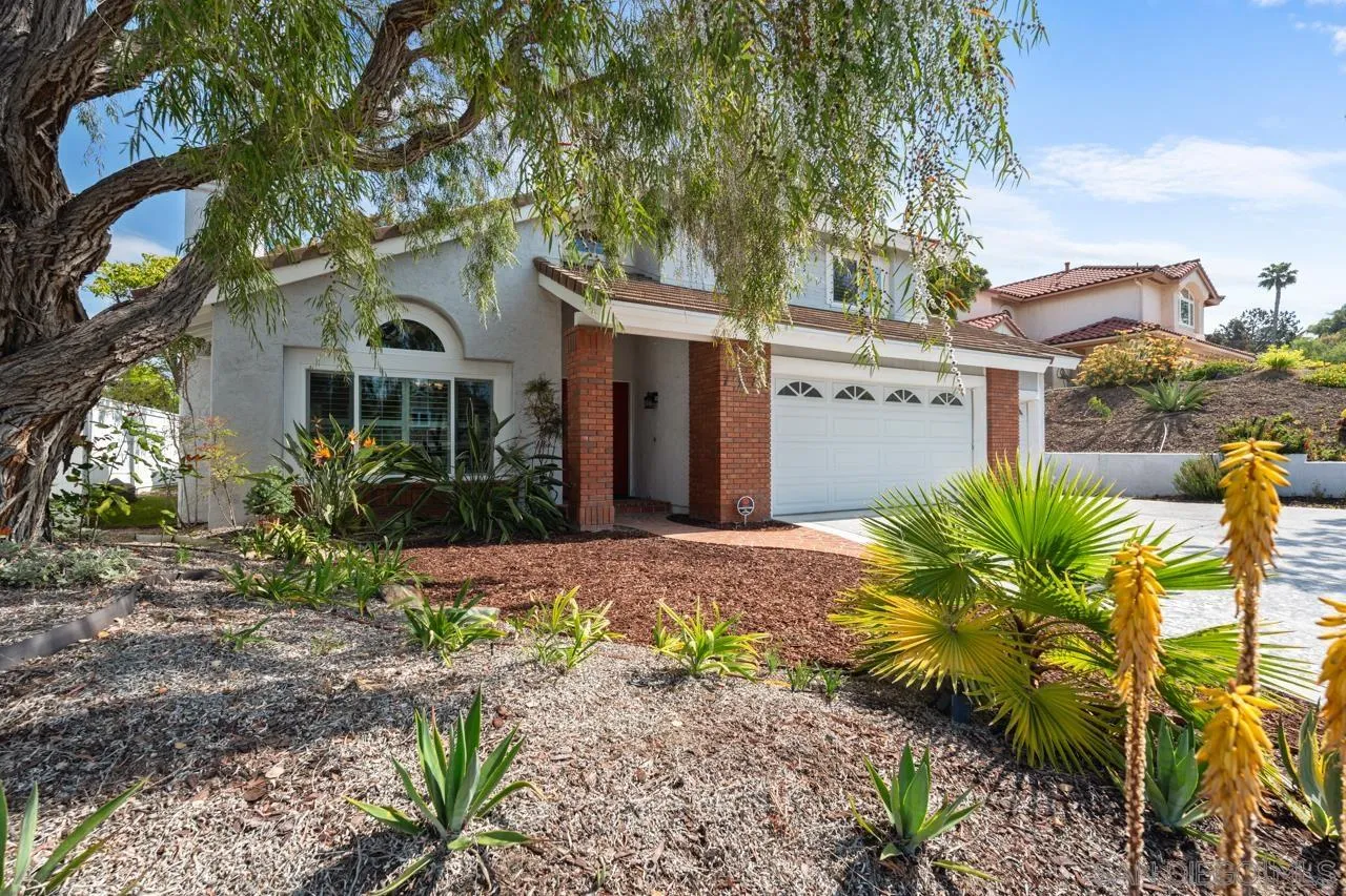 7914 Corte Cardo Carlsbad, CA 92009 - Photo 3 of 61 a white house with a large tree in front of it