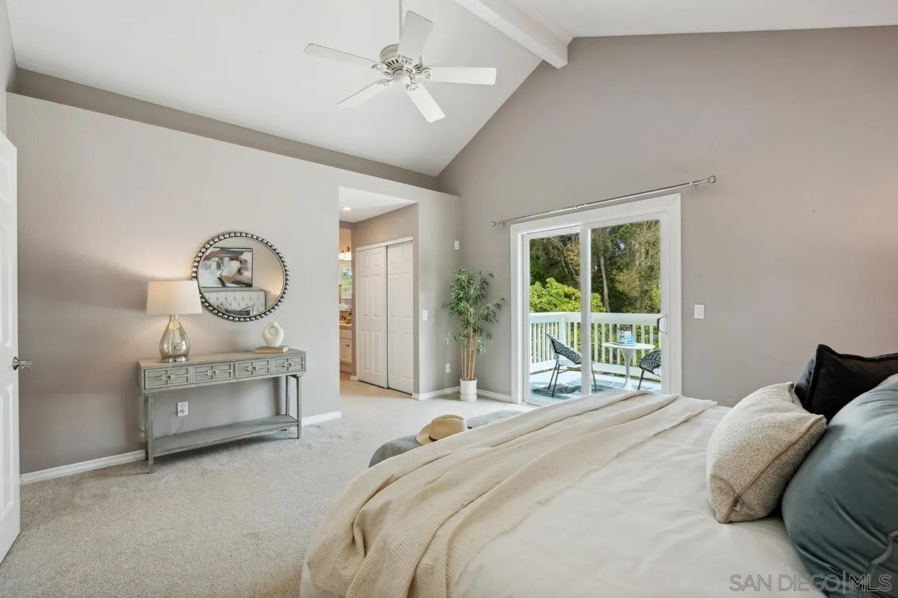 7914 Corte Cardo Carlsbad, CA 92009 - Photo 31 of 61 a bedroom with a bed and a large window