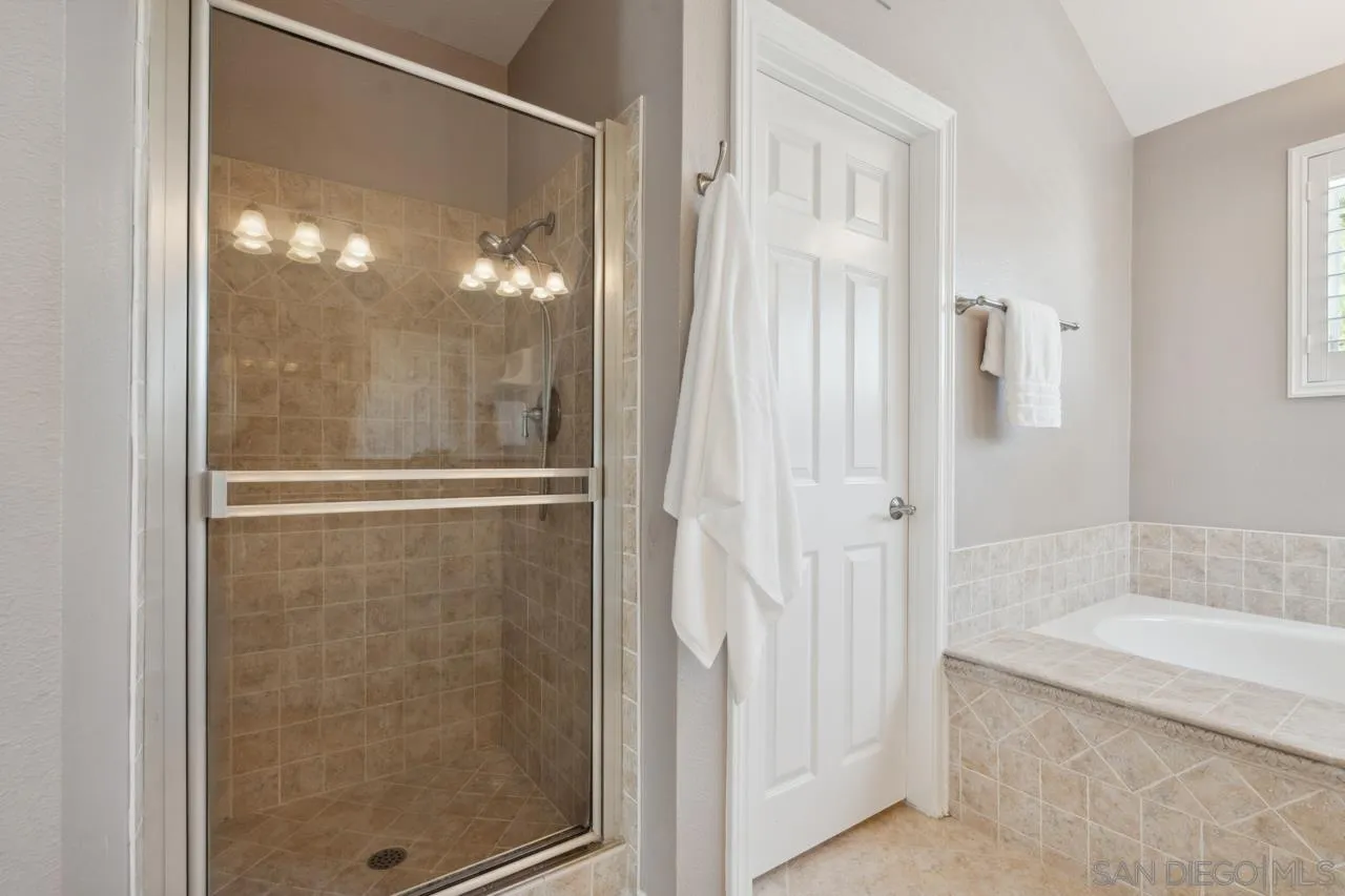 7914 Corte Cardo Carlsbad, CA 92009 - Photo 35 of 61 a bathroom with a glass shower door
