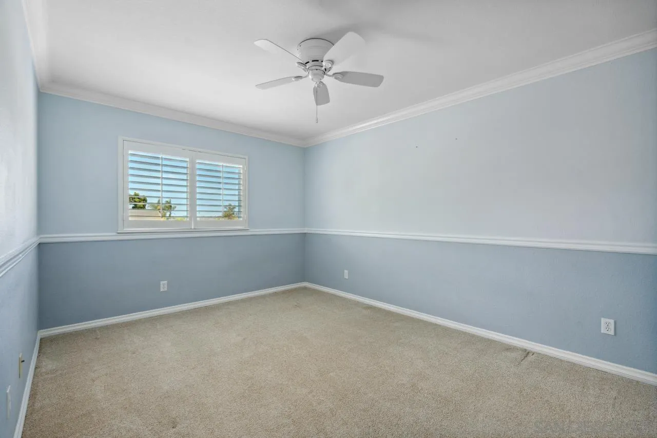 7914 Corte Cardo Carlsbad, CA 92009 - Photo 39 of 61 an empty room with a window and a ceiling fan