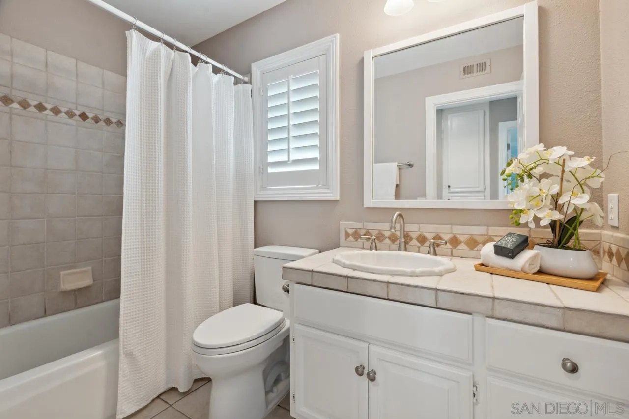 7914 Corte Cardo Carlsbad, CA 92009 - Photo 40 of 61 a bathroom with a sink a toilet and shower