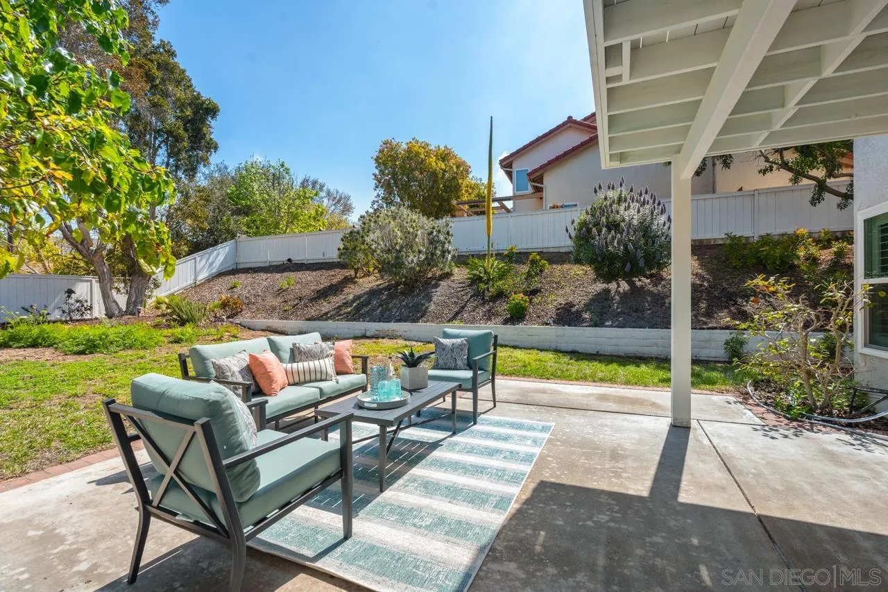 7914 Corte Cardo Carlsbad, CA 92009 - Photo 43 of 61 a view of a patio with couches table and chairs and potted plants