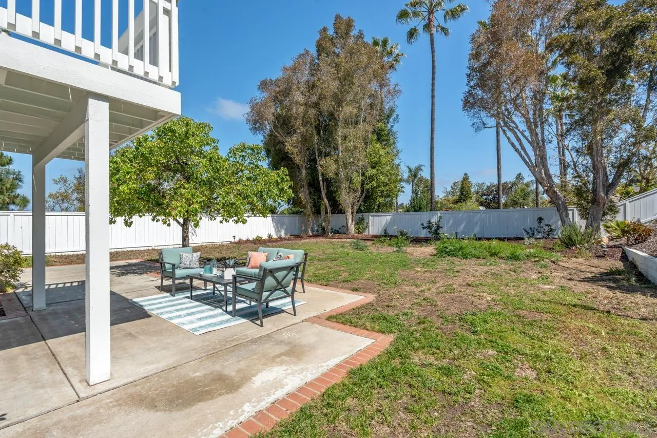 7914 Corte Cardo Carlsbad, CA 92009 - Photo 44 of 61 a view of a patio with a table and chairs and potted plants