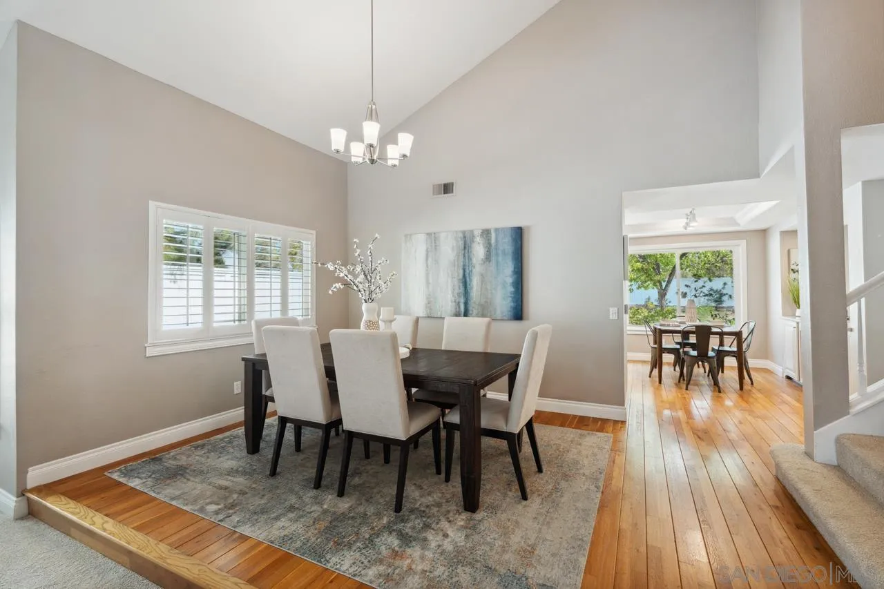 7914 Corte Cardo Carlsbad, CA 92009 - Photo 10 of 61 a view of a dining room with furniture window and wooden floor