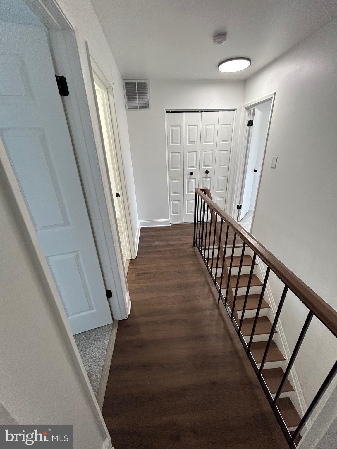 7036 Palamar Terrace Lanham, MD 20706 - Photo 15 of 34 a view of a hallway with wooden floor and staircase