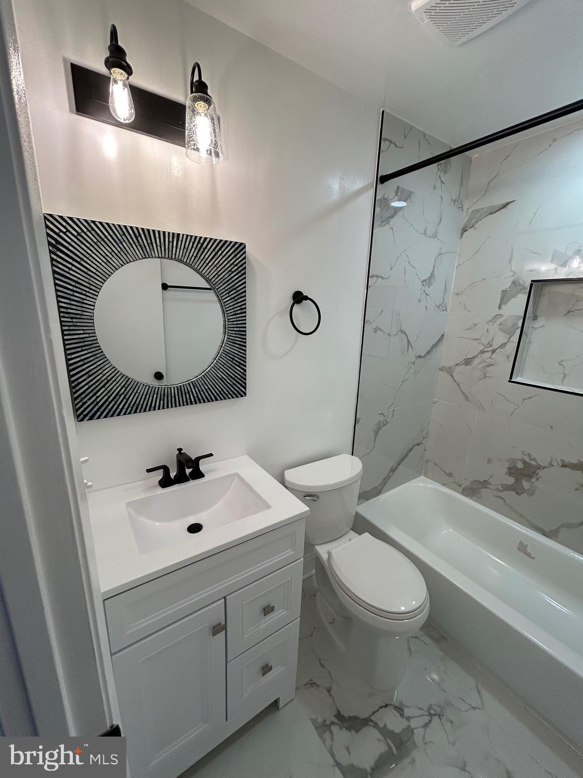 7036 Palamar Terrace Lanham, MD 20706 - Photo 16 of 34 a bathroom with a sink a toilet and a bathtub