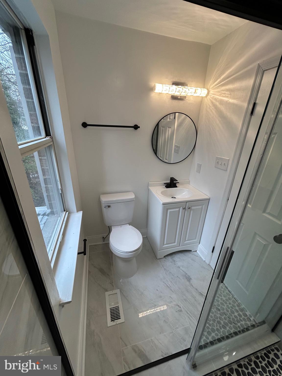 7036 Palamar Terrace Lanham, MD 20706 - Photo 18 of 34 a bathroom with a sink mirror vanity and toilet