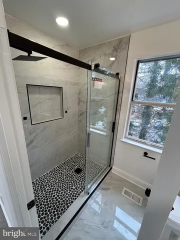 a bathroom with a shower and a sink