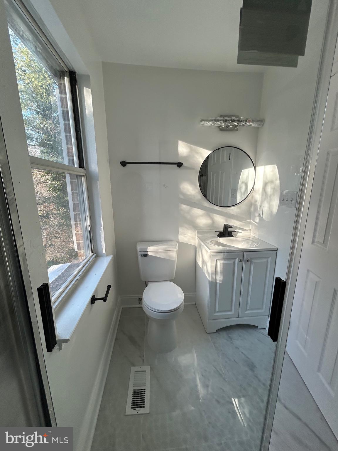 7036 Palamar Terrace Lanham, MD 20706 - Photo 27 of 34 a bathroom with a toilet a sink and a window