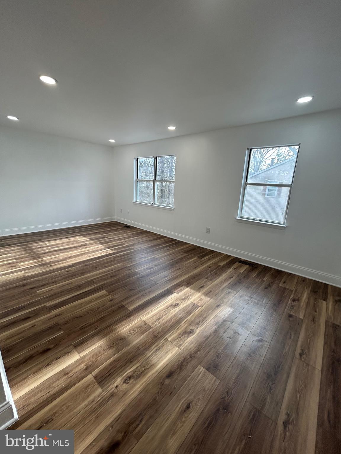 7036 Palamar Terrace Lanham, MD 20706 - Photo 7 of 34 an empty room with wooden floor and windows