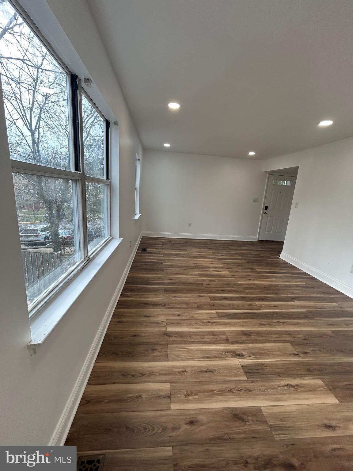 7036 Palamar Terrace Lanham, MD 20706 - Photo 8 of 34 a view of a big room with wooden floor and windows