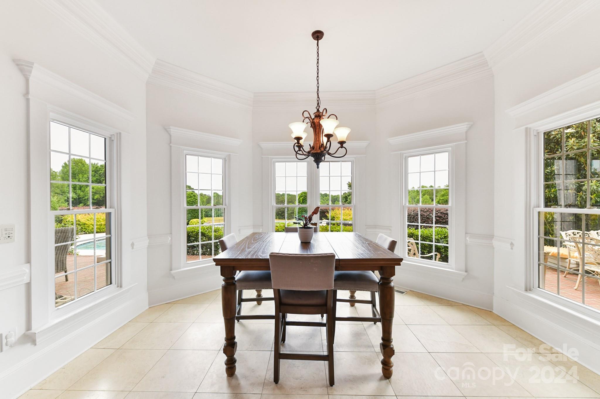 8275 Mt Olive Road Concord, NC 28025 - Photo 12 of 47 a dining room with furniture a chandelier and wooden floor
