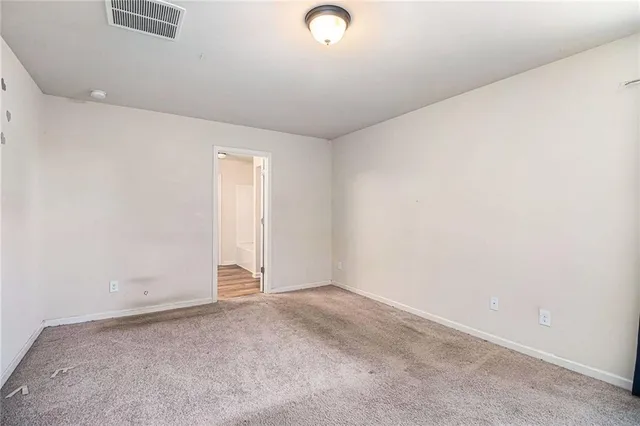 a bedroom with a bed and a lamp