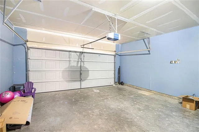 a view of a backyard with table and chairs potted plants and tree