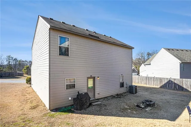 a view of a brick house with chair and tables
