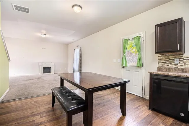 a view of kitchen with cabinets and wooden floor