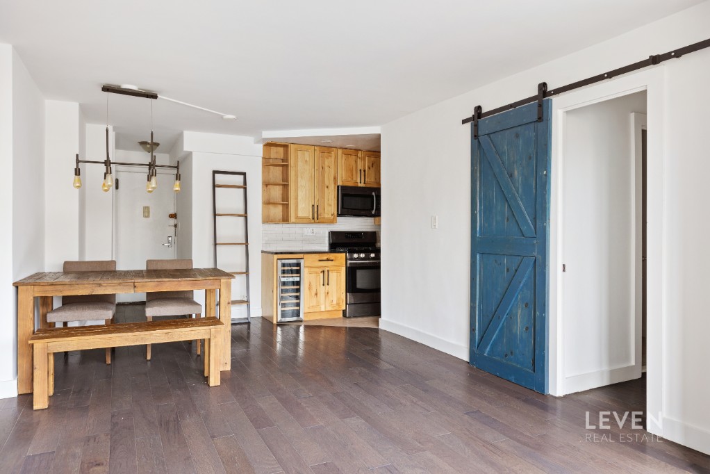 333 East 14th Street, Unit 9A Manhattan, NY 10003 - Photo 2 of 8 a livingroom with furniture and wooden floor