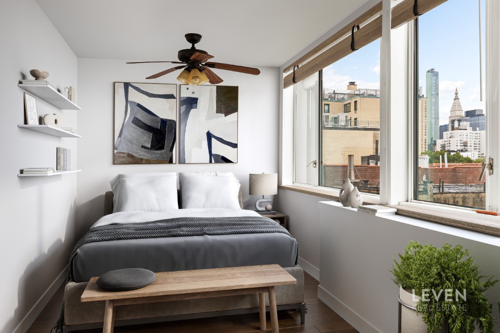 333 East 14th Street, Unit 9A Manhattan, NY 10003 - Photo 4 of 8 a bedroom with a bed and a large window