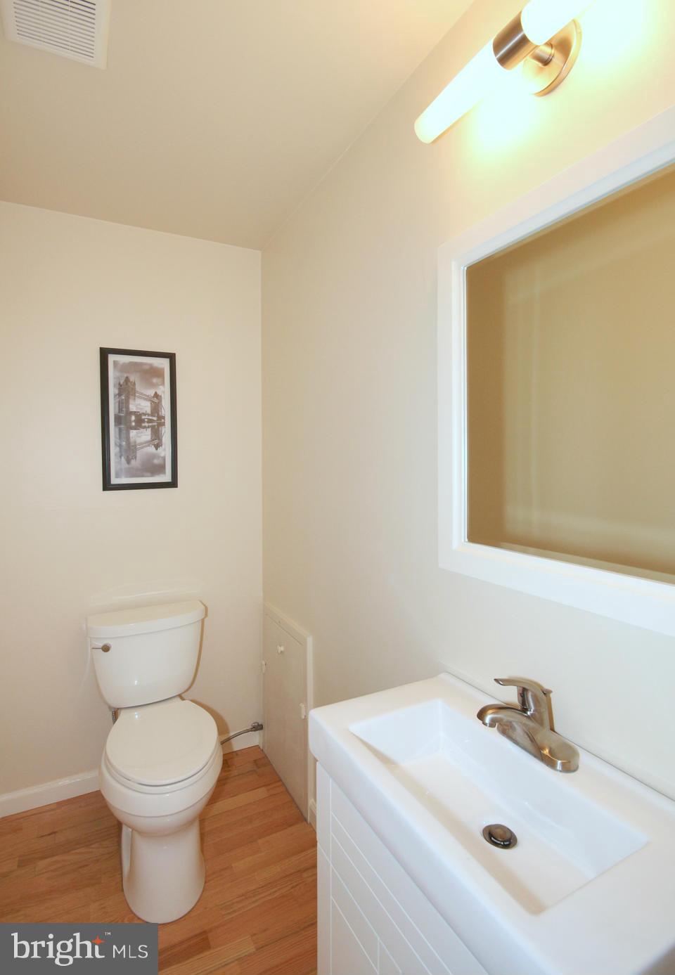 5216 Dalton Road Springfield, VA 22151 - Photo 22 of 27 a bathroom with a toilet a sink and mirror