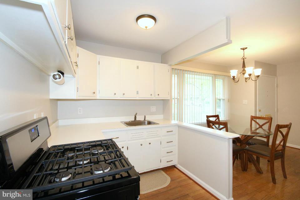 5216 Dalton Road Springfield, VA 22151 - Photo 5 of 27 a kitchen that has a lot of cabinets in it and wooden floors