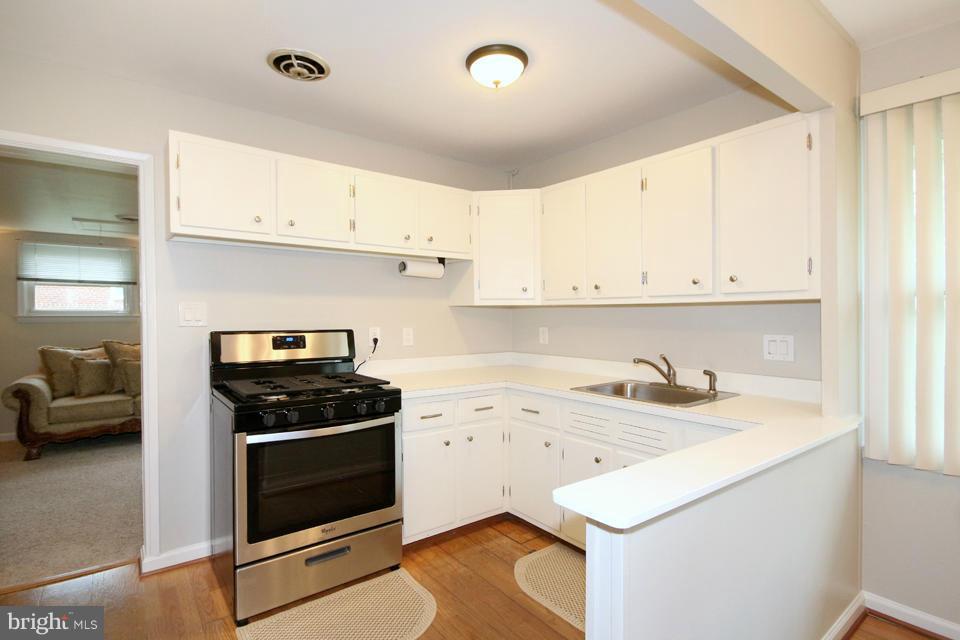 5216 Dalton Road Springfield, VA 22151 - Photo 6 of 27 a kitchen with a sink stove and cabinets