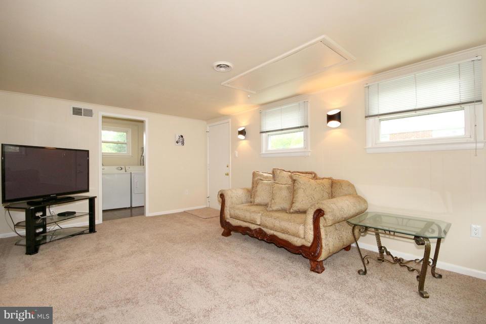 5216 Dalton Road Springfield, VA 22151 - Photo 9 of 27 a living room with furniture and a flat screen tv