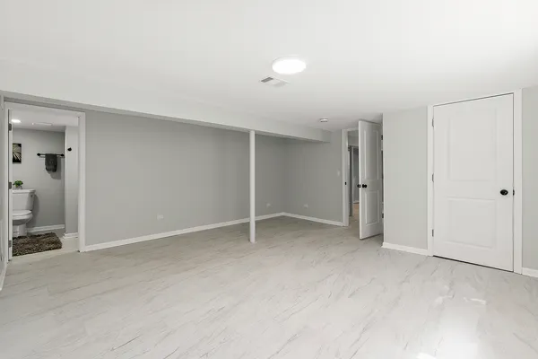 a white toilet sitting next to a bathroom sink
