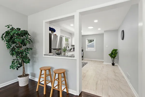 a kitchen with granite countertop a refrigerator and a stove