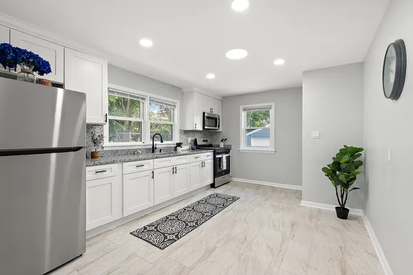 a kitchen with granite countertop a sink and a stove
