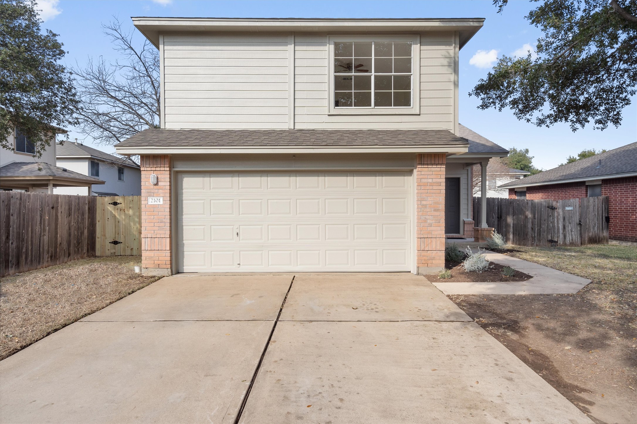 2101 Jester Farms Road Round Rock, TX 78664 - Photo 1 of 24 View of front of property featuring brick siding, a garage, driveway, and a shingled roof