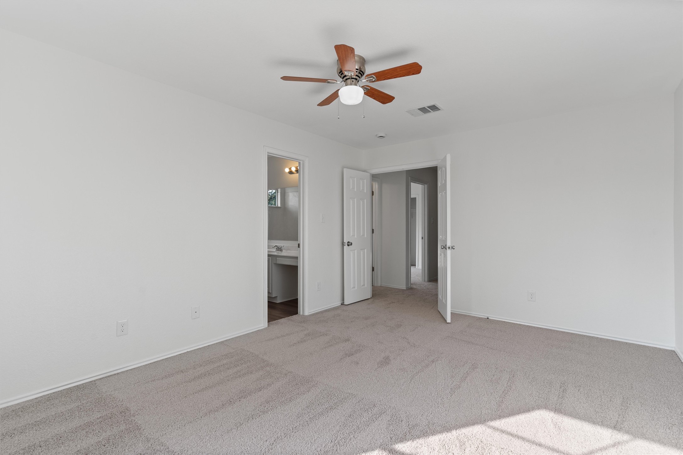 2101 Jester Farms Road Round Rock, TX 78664 - Photo 15 of 24 Unfurnished bedroom with carpet, ceiling fan, and connected bathroom