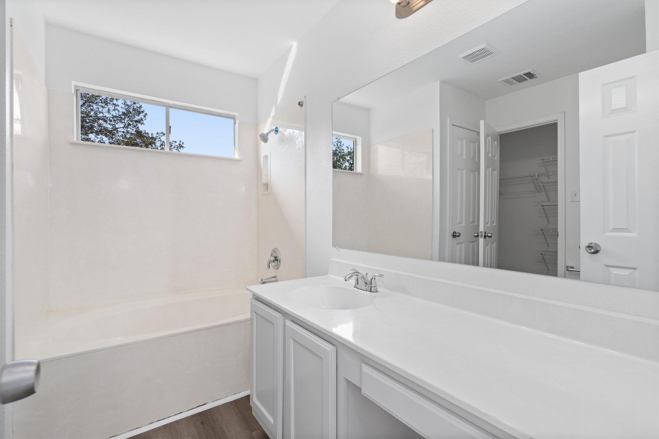2101 Jester Farms Road Round Rock, TX 78664 - Photo 16 of 24 Full bathroom featuring vanity, a walk in closet, shower / tub combination, and dark wood-style flooring