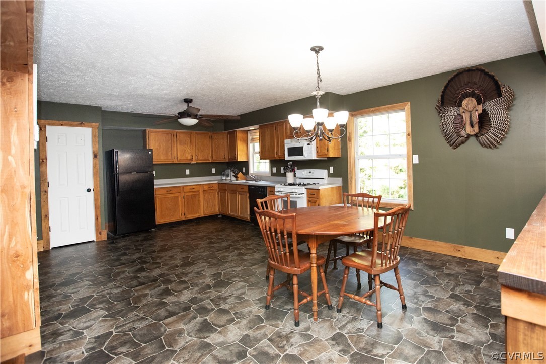 2232 Mt Pleasant Road Pamplin, VA 23958 - Photo 13 of 50 a kitchen with stainless steel appliances granite countertop a sink a stove a dining table and chairs