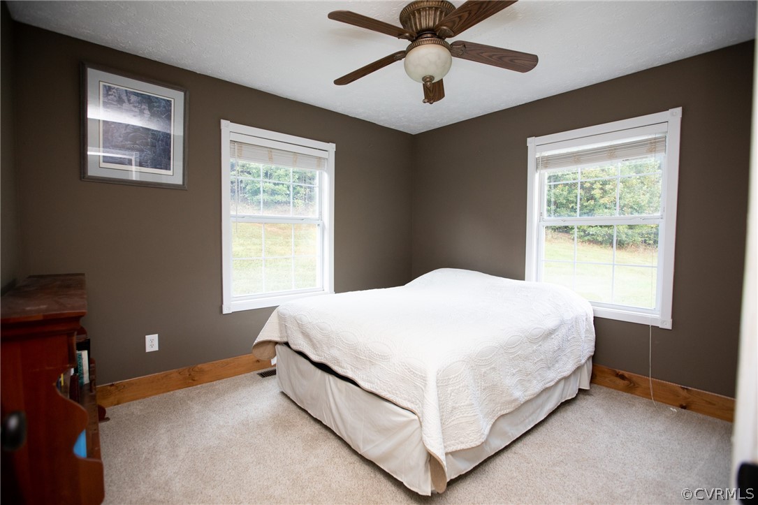 2232 Mt Pleasant Road Pamplin, VA 23958 - Photo 23 of 50 a bed sitting in a bedroom next to a window