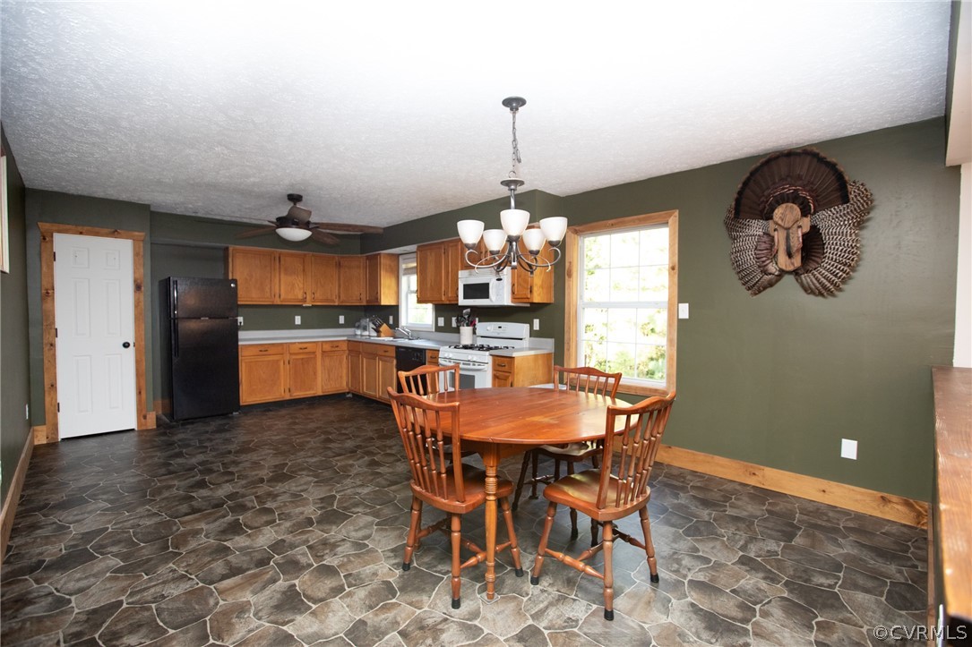 2232 Mt Pleasant Road Pamplin, VA 23958 - Photo 9 of 50 a view of a dining room and a kitchen with a table chairs