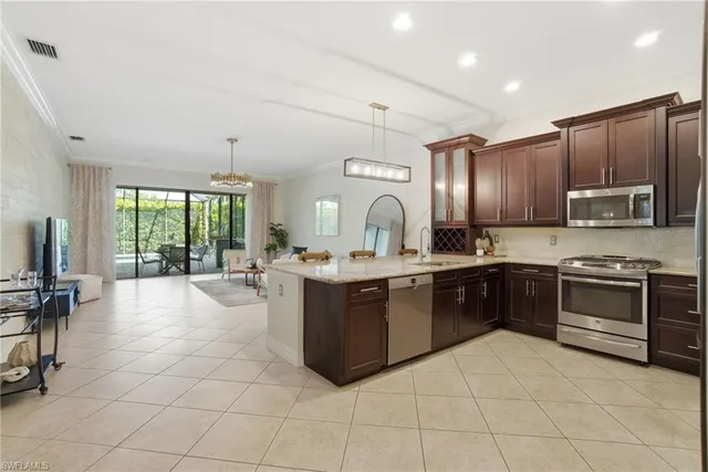 a large kitchen with kitchen island granite countertop a large counter top and appliances