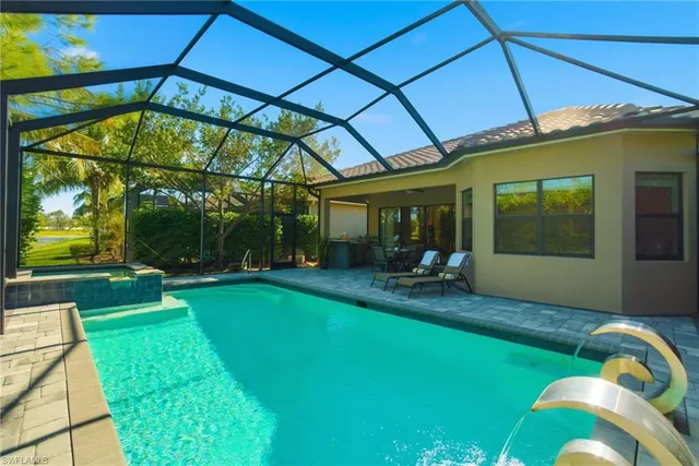 a view of a chair and table in backyard of the house